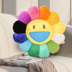 a sunflower stuffed animal sitting on top of a couch