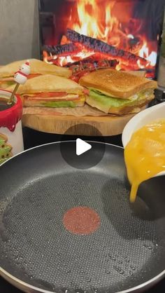 a pan with some food on it next to a fire