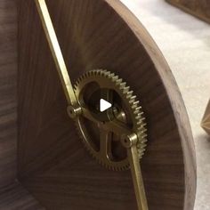 a close up of a wooden clock with gears on it