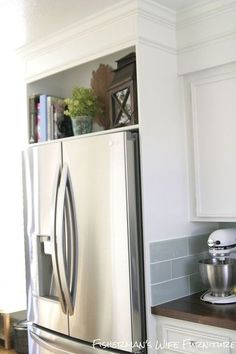 a silver refrigerator freezer sitting inside of a kitchen