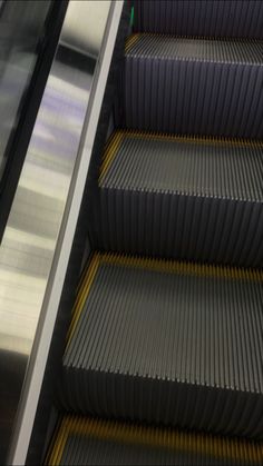 an escalator that is going down the stairs