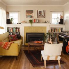 a living room filled with furniture and a fire place next to a fireplace covered in books