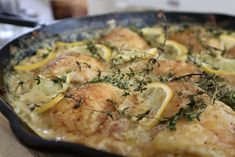 chicken with lemons and herbs in a skillet