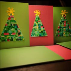 three christmas trees made out of paper on top of green and red cards with yellow bows