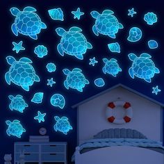 the glow turtle wall decals are in blue and white colors, with an ocean theme