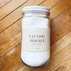 a jar filled with laundry powder sitting on top of a wooden floor