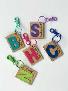 four wooden blocks with letters and numbers attached to each other on a white table top