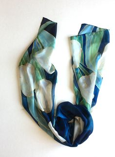 "Welcome to klaradar! https://www.etsy.com/uk/shop/klaradar?ref=seller-platform-mcnav Navy Tulips Silk Scarf/ Hand Painted Scarf/ Dark Blue Floral scarf painted. White Tulips painted on Deep Blue background. Unique handmade gift for women, Christmas gift mom. Silk Painting by Klaradar/ Christmas gift for mother-in-law. ►measurements- 17\"x71\" This Blue Tulips Scarf is painted on pure silk pongee 5. ►SHIP NEXT DAY See my luxury scarves and shawls here: https://www.etsy.com/shop/klaradar?ref=l2-s Christmas Gift Mom, Tulip Painting, Velvet Scarf, Hand Painted Scarves, Yellow Scarf, Painted Scarf, Blue Tulips, Silk Scarf Painting, Luxury Scarves