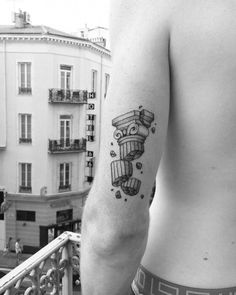 a black and white photo of a man's arm with a tattoo on it