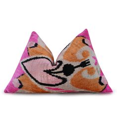 a pink and orange cat pillow on a white background