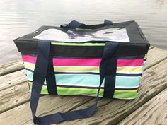 a colorful bag sitting on top of a wooden dock