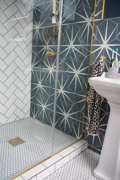 a white sink sitting next to a walk in shower