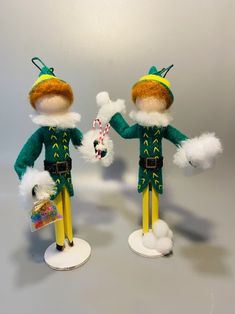 two elf dolls standing next to each other