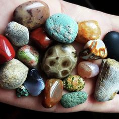 a person's hand is full of different rocks and stones that are on their palm