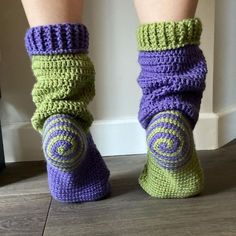 the legs and ankles of a woman wearing crocheted socks with spirals on them