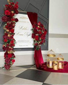 a red and gold wedding arch decorated with flowers