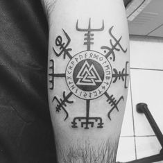 a man with a tattoo on his arm has an illuminate symbol in the middle