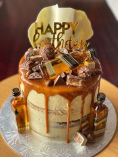 a birthday cake that is sitting on top of a table with bottles and condiments