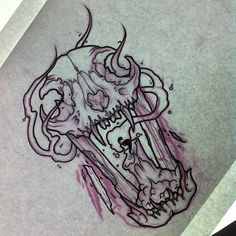 a drawing of a skull on paper with ink splatters all over the surface