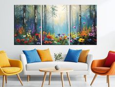 three paintings on the wall of a living room