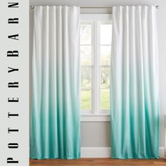 the curtain is hanging in front of a window with white and blue ombreed curtains