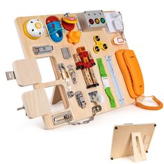 a wooden toy with many different items on it's back side and an orange phone in the middle