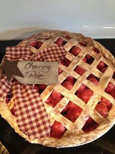 a pie that is sitting on top of a table next to a sign with the words merry pie written on it