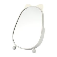 a white cat shaped mirror on top of a table