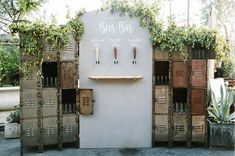 a bunch of lockers that are next to each other with plants growing on them