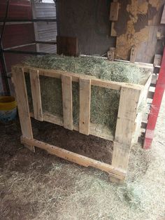 a wooden box with hay inside of it