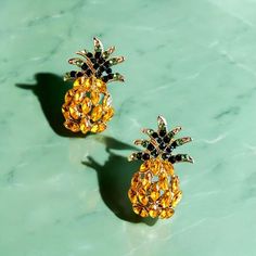 1.22 inches long x .79 inches wide Beautiful rhinestone Pineapple earrings with silver plated hypoallergenic post and rubber backs.  They have a beautiful gold and green sparkle that makes them very appealing and eye catching. Pineapple Earrings, Earrings Trendy, Gold And Green, Trendy Earrings, Rhinestone Earrings, Jewelry Earrings Studs, Pineapple, Silver Plated, Halloween Shopping