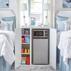 a room with two beds and a refrigerator