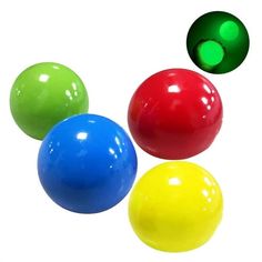 three different colored balls are in the air