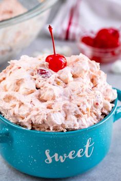 a close up of a bowl of food with a cherry on top and the words sweet written in it