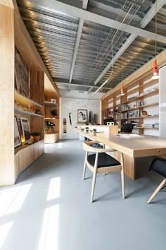 an empty room with wooden shelves and chairs