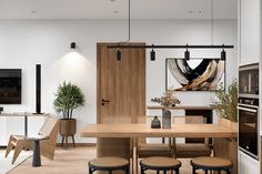 an open concept kitchen and dining room with wood accents, white walls and flooring