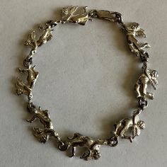 Sterling Silver Angels Bracelet Is 7 1/2” Inches Long Each Cherub Is Almost An Inch Long And There Are Eight Outstretched Cherubs Flying Around Your Wrist When Worn. Vintage Patina I Will Not Polish It. Your Item Will Be Beautifully Packaged With Care And Shipped The Same Or Next Day. Thank You For Shopping @Pixielife 325 Sterling Silver Jewelry Bracelets Cherubs Angelic Angels Accessory Accessories Long Vintage Patina Woman Women Gifts Gift Girls Birthday Anniversary Graduation Trending Christmas Bells Vintage Silver Bracelets With Dangling Charms, Silver Vintage Charm Costume Bracelet, Angel Accessories, Silver Spiritual Vintage Charm, Sterling Silver Jewelry Bracelets, Adjustable Vintage Nickel-free Charm Bracelet, Angel Bracelet, Vintage Hallmarked Sterling Silver Charm Bracelet, Christmas Trends