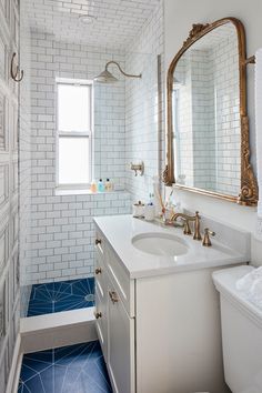 a bathroom with blue and white tile on the floor