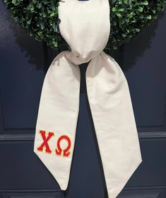 a white scarf with the letters xo on it