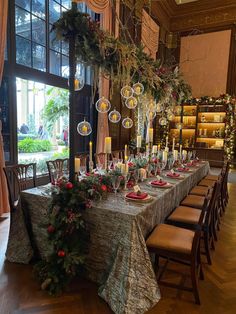 a long table is set with candles and christmas decorations