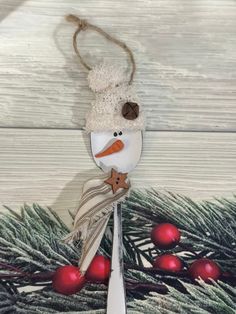 a spoon with a snowman decoration on it