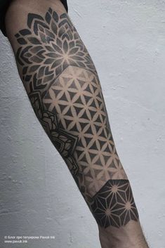 a man's arm with an intricate tattoo design on the left side of his arm