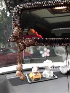 the rear view mirror of a car with beads hanging from it