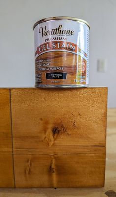 a can of paint sitting on top of a wooden block