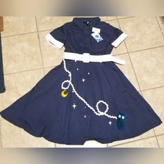 a dress made to look like the moon and stars on it, with a belt around the waist