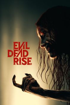 the evil dead rise movie poster with a woman holding her arm out and looking down