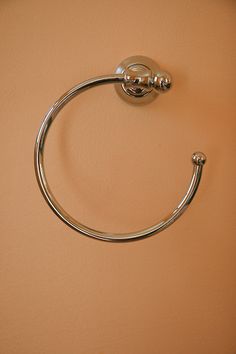 a close up of a towel ring on a wall with a light brown colored background