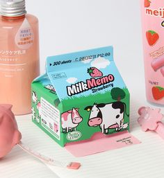 a pink pig next to milk and other items