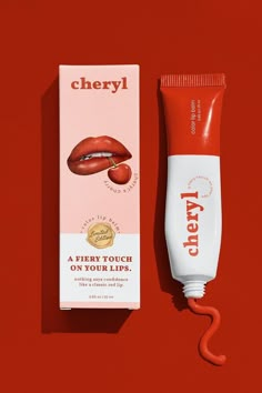 a tube of lip cream next to a box of lip glosses on a red background