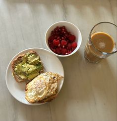 there are two plates with food and a cup of coffee on the table next to it